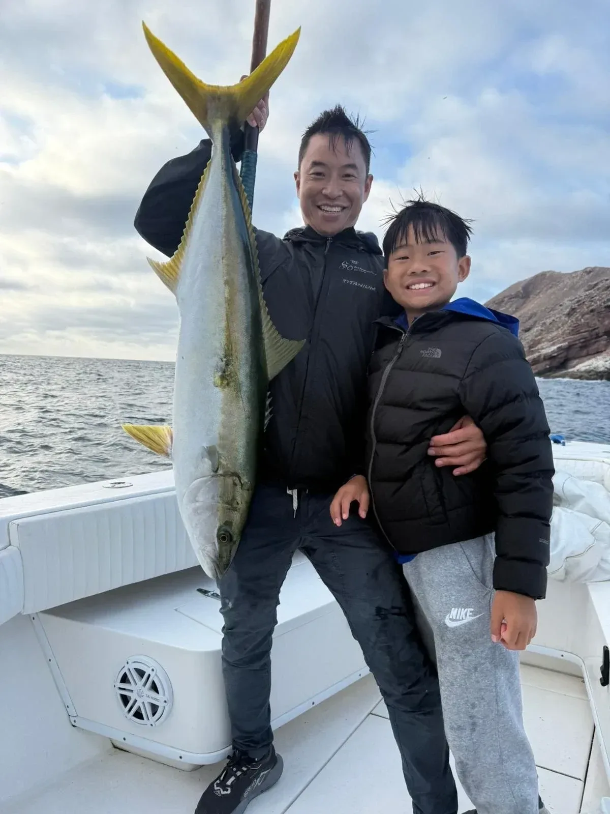 Father and son with a yellowtail